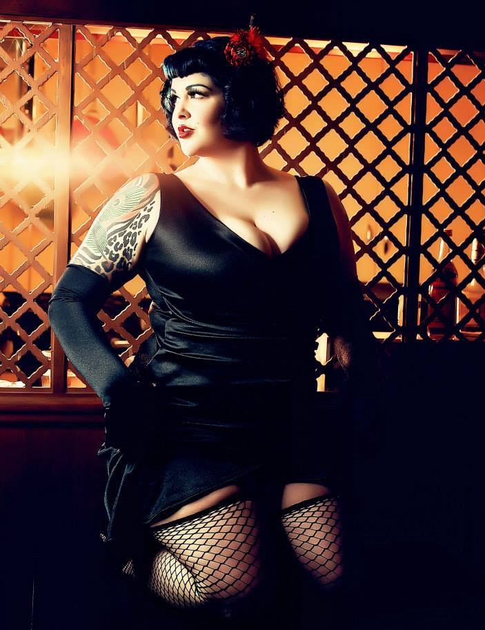 Brunette Pin Up BBW wearing Black Fishnet Stockings and Black Satin Dress